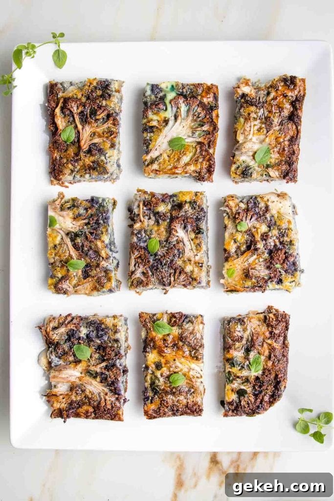 Plate with pieces of cauliflower kugel sprinkled with fresh oregano.