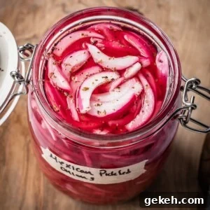 An opened jar of pickled Mexican onions with a label on a wooden board.