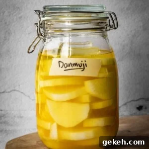 A jar with sliced daikon radish in a pickling solution, with a Danmuji label.