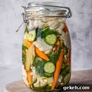 Large pickling crock filled with pickled Italian vegetables, herbs and spices.