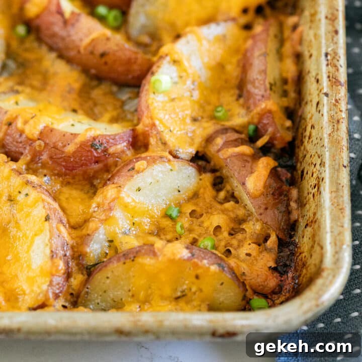 The corner of a pan of cheesy ranch potatoes.
