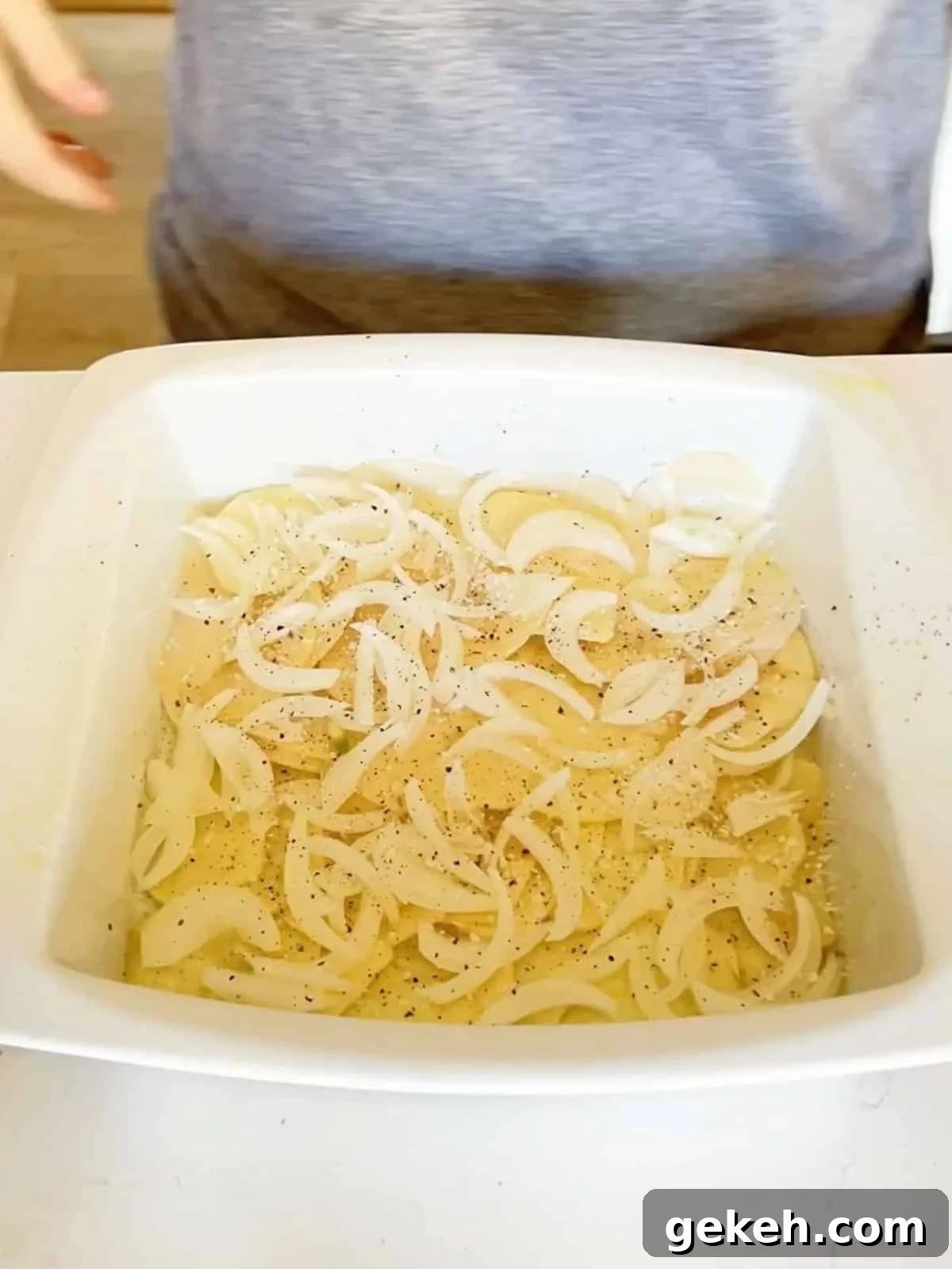 Classic Creamy Scalloped Potatoes Recipe from Mom 6 Thin sliced onions and salt and pepper added to the potatoes in the pan.