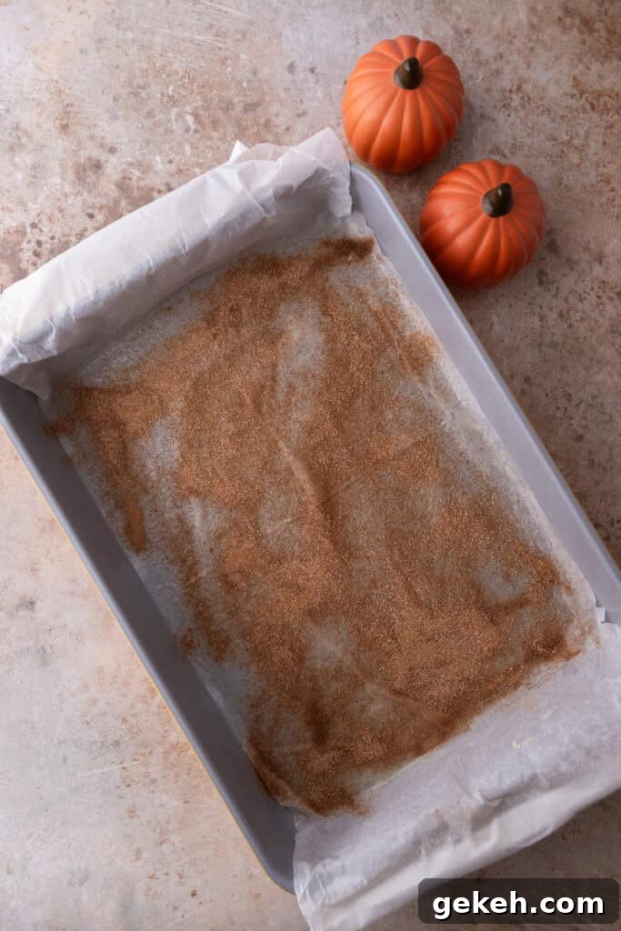 Churro Pumpkin Cheesecake Bars Recipe — Step-by-Step Guide 5 greased parchment with cinnamon sugar in a pan