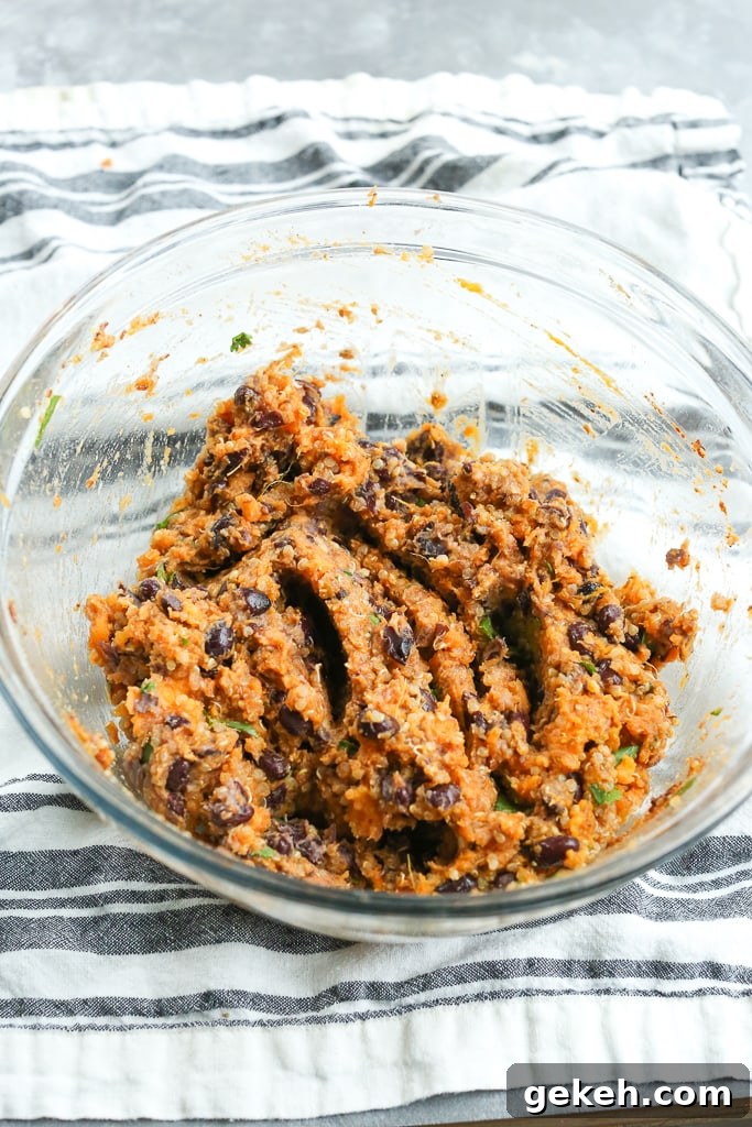 Sweet Potato and Black Bean Burger Recipe for Flavorful Veggie Patties 6 mashed ingredients (sweet potato, black beans, quinoa, and spices) in a glass bowl