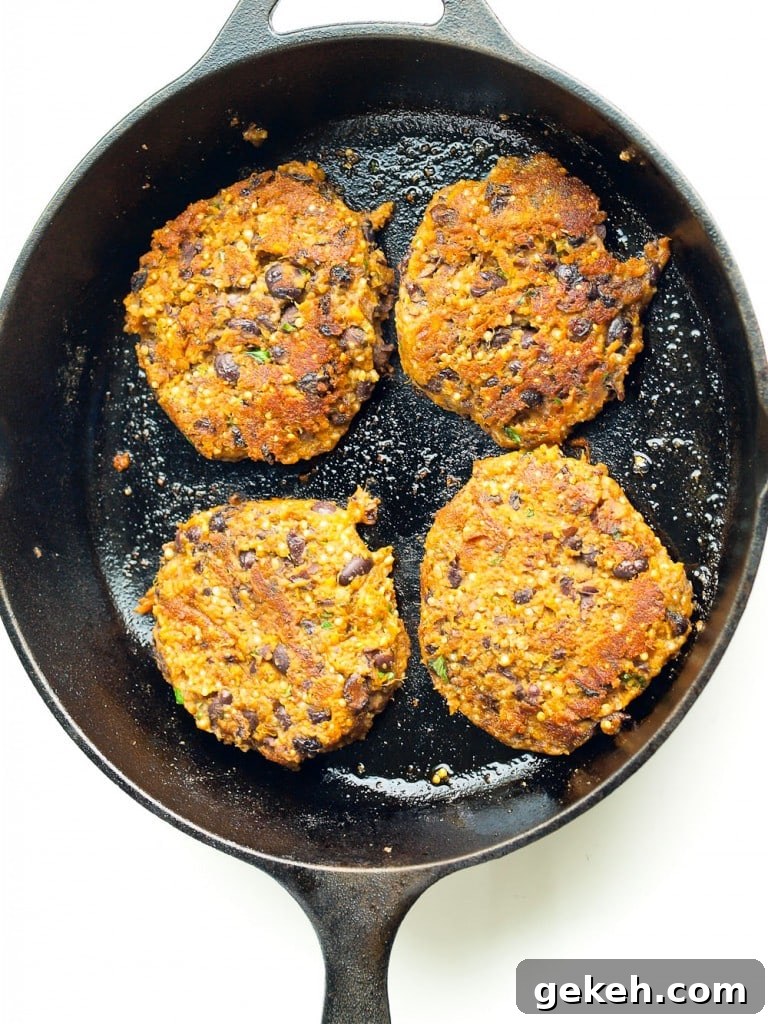 Sweet Potato and Black Bean Burger Recipe for Flavorful Veggie Patties 7 four sweet potato black bean patties in a cast iron skillet, overhead shot