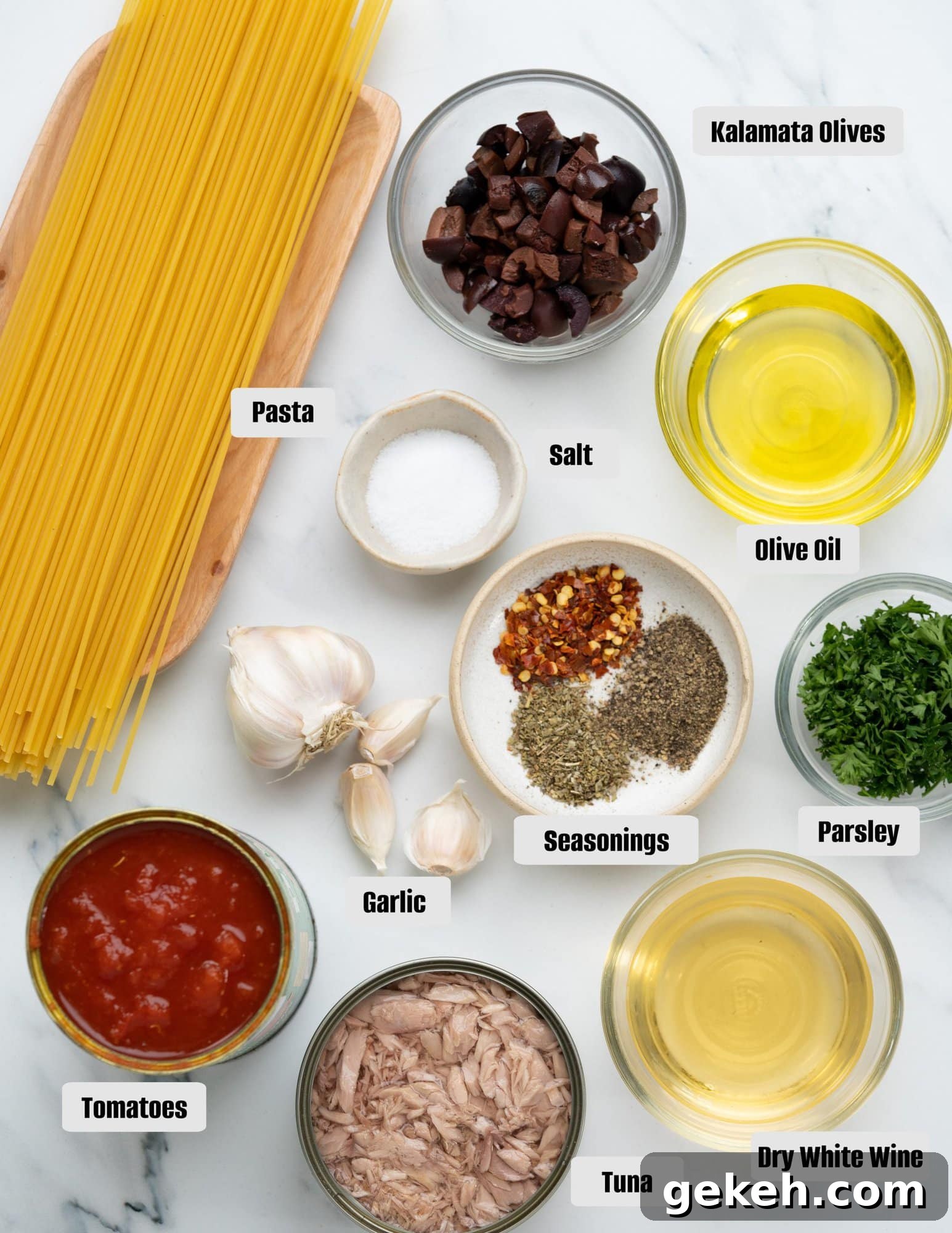 Quick Canned Tuna Pasta Recipe for Weeknight Dinners 4 Ingredients - Spaghetti, Tuna, Tomatoes, Kalamata olives, olive oil, white wine, parsley, garlic and seasonings.