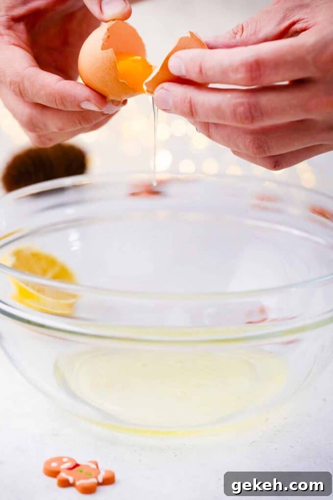 How to Make Smooth Royal Icing for Perfect Cookies and Cakes 4 craving an egg on top of a large bowl with egg whites in it