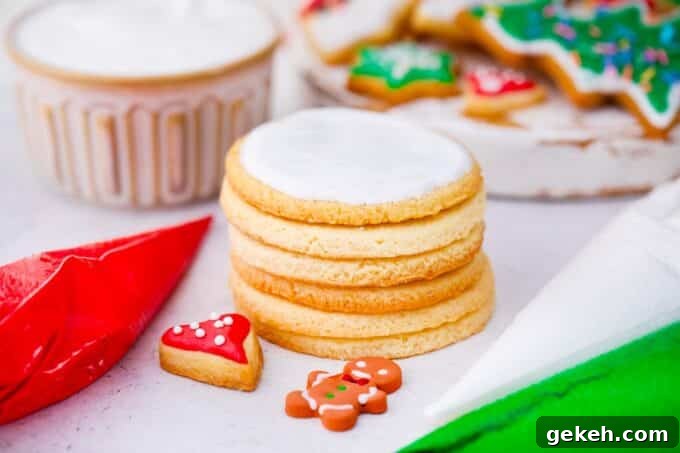 How to Make Smooth Royal Icing for Perfect Cookies and Cakes 9 a stack of sugar cookies topped with royal icing with piping bags filled with royal icing next to them