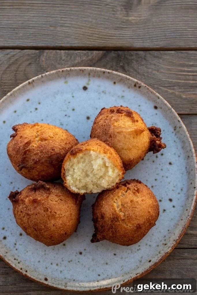 Coconut doughnuts on a plate with one opened up