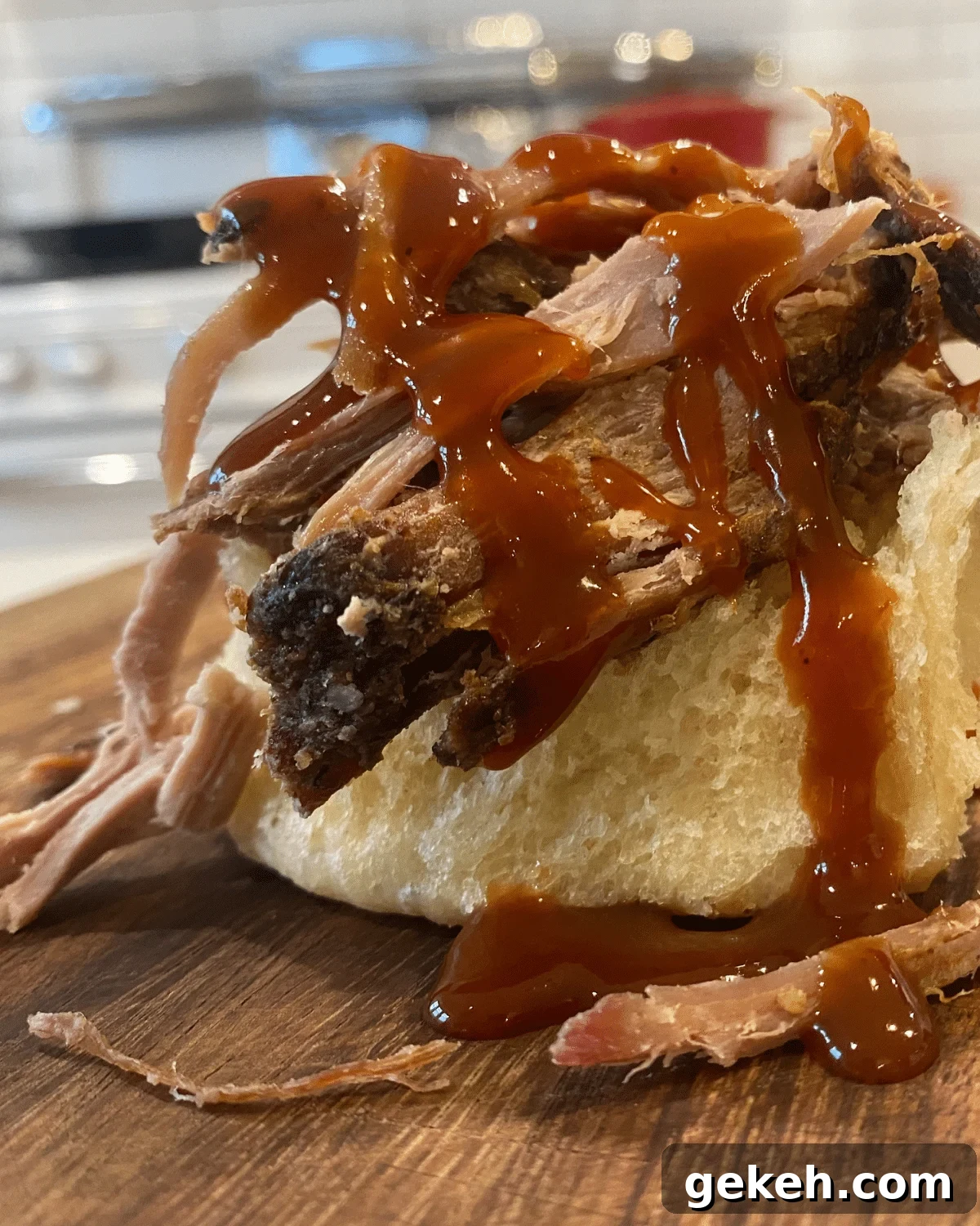 boston butt roast pulled pork on bun with BBQ sauce