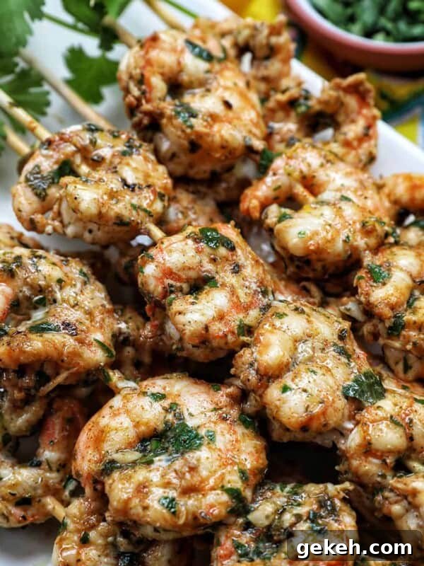 Refreshing Summer Salad Recipes for Light, Flavorful Meals 26 prawn BBQ skewers stacked on a plate.