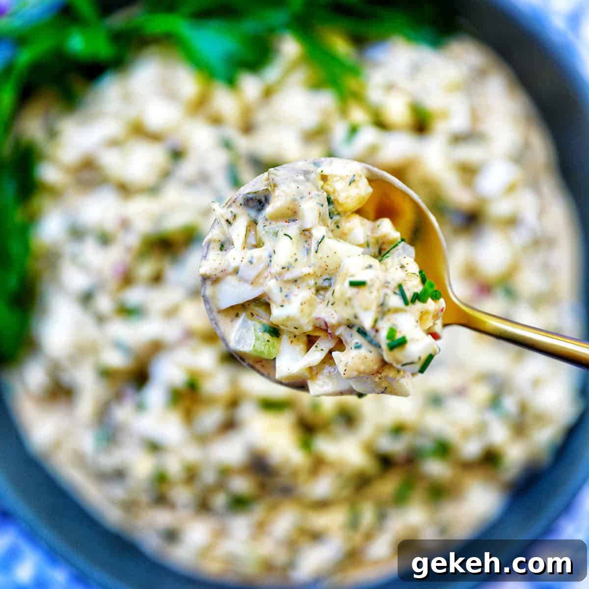 spoonful of egg salad over a bowl of dill pickle egg salad.