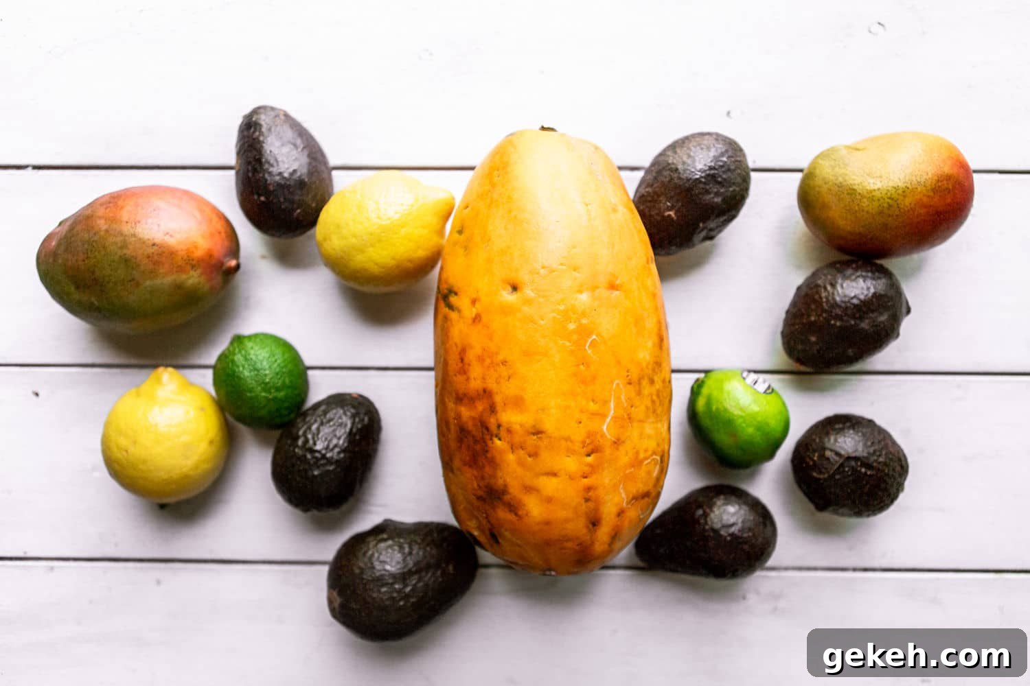 Ethiopian Spices: Authentic Flavors and Cooking Tips 3 papaya, mangoes, avocados, lemons, and limes on a white surface.