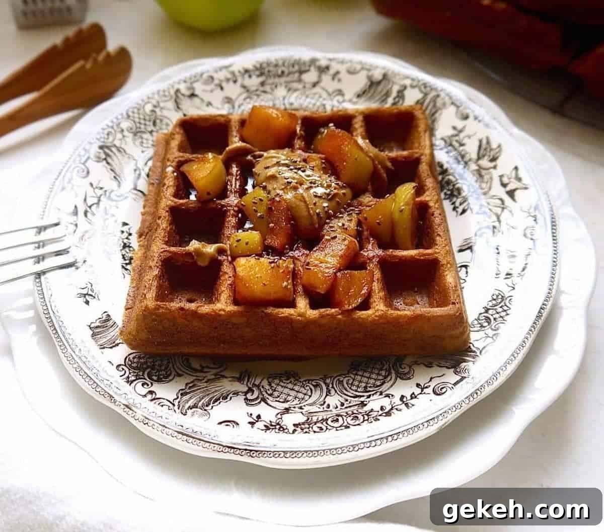 Gluten-Free Apple Cinnamon Waffles (Paleo-Friendly) 6 Paleo apple cinnamon waffles on a plate with apples on top.