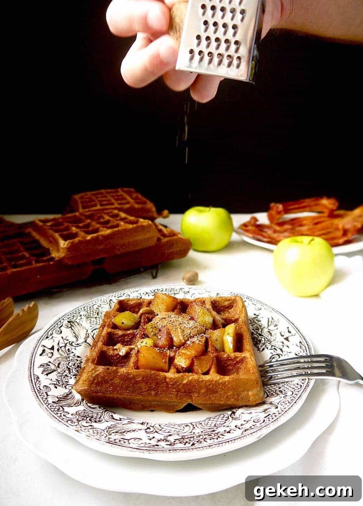 Gluten-Free Apple Cinnamon Waffles (Paleo-Friendly) 7 Healthy apple waffles with nutmeg being put on top.