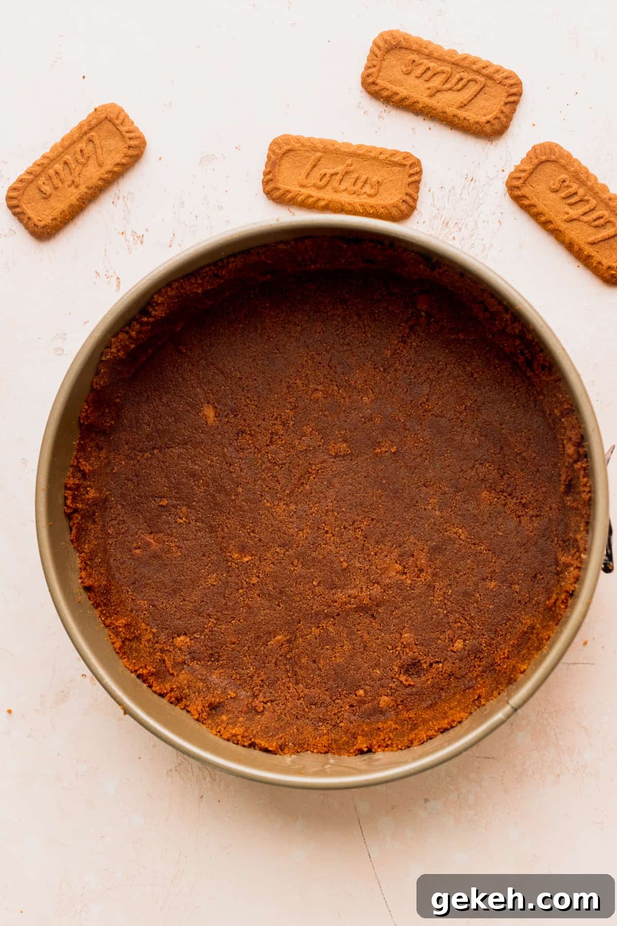 Biscoff cookie crust in a springform pan.