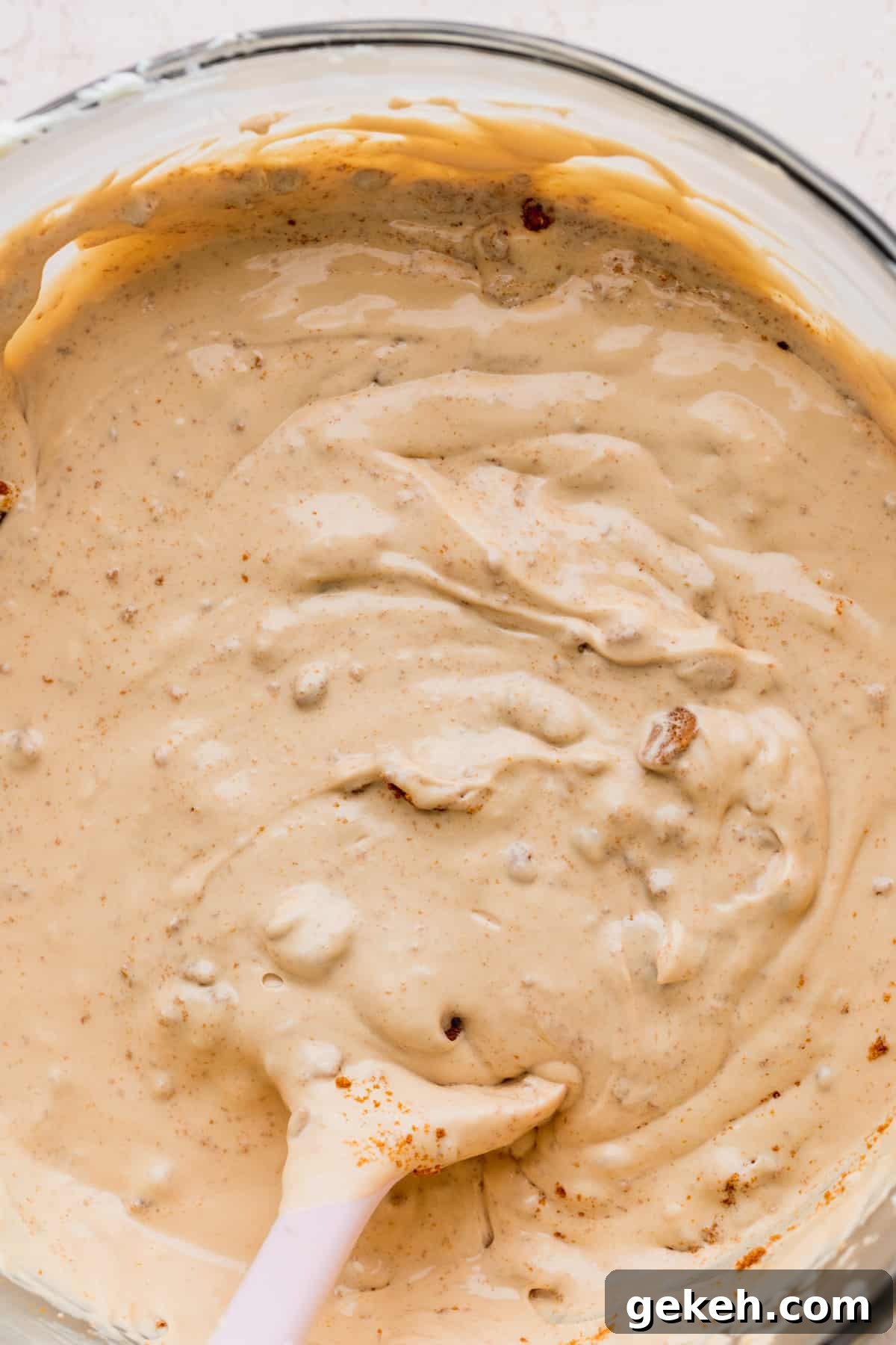 Close up of cheesecake batter in a glass bowl.