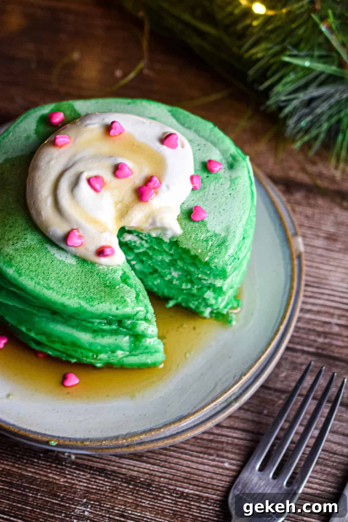 Homemade Grinch Pancakes Recipe — Green St. Patrick’s Breakfast 9 A piece of the Grinch pancake stack is cut out.
