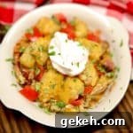 Hearty Cowboy Casserole Recipe with Cheesy Beef and Beans 2 Bowl of tater tot casserole with sour cream.