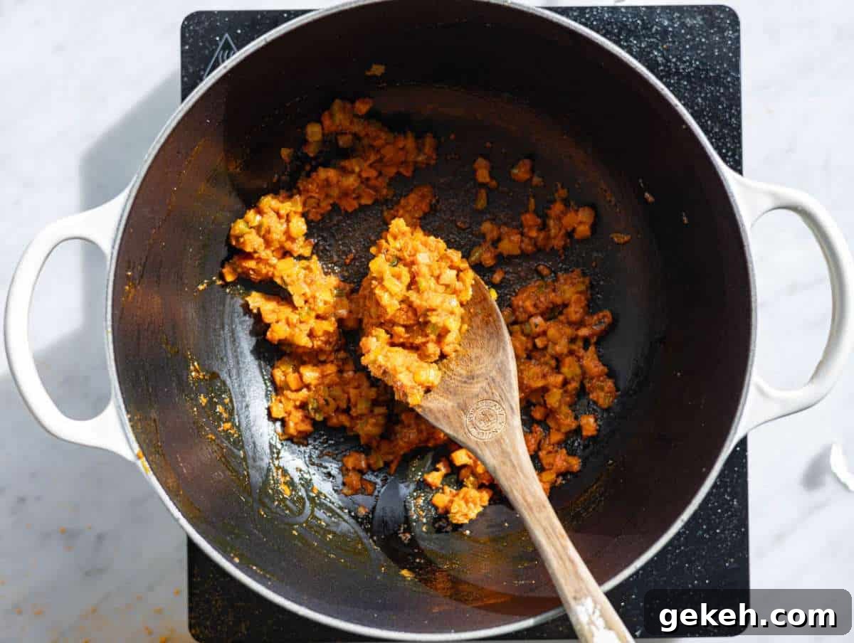 Step 2 Tomato paste garlic and spices stirred into softened vegetables.