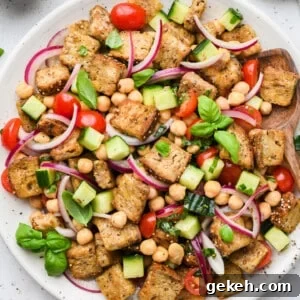Chickpea Panzanella Salad with Tomatoes, Cucumbers & Basil 2 Overhead view of panzanella salad on white serving platter