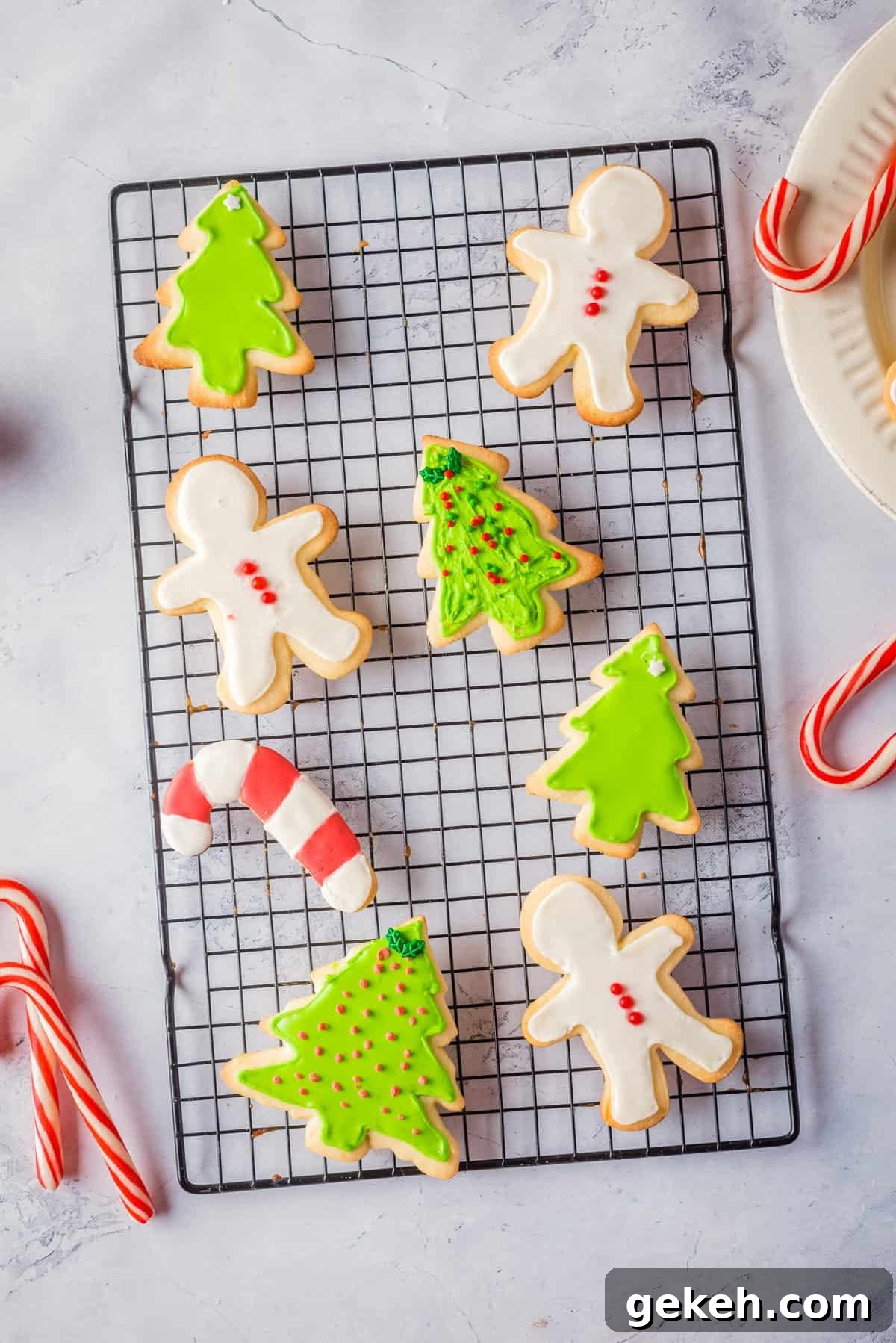 Overhead view of Christmas sugar cookies on a black wire rack.