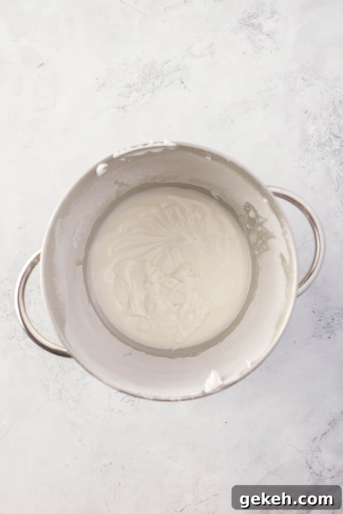 Overhead view of icing mixture after being fully mixed, with stiff peaks.