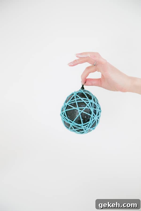Balloon wrapped in yarn with glue.