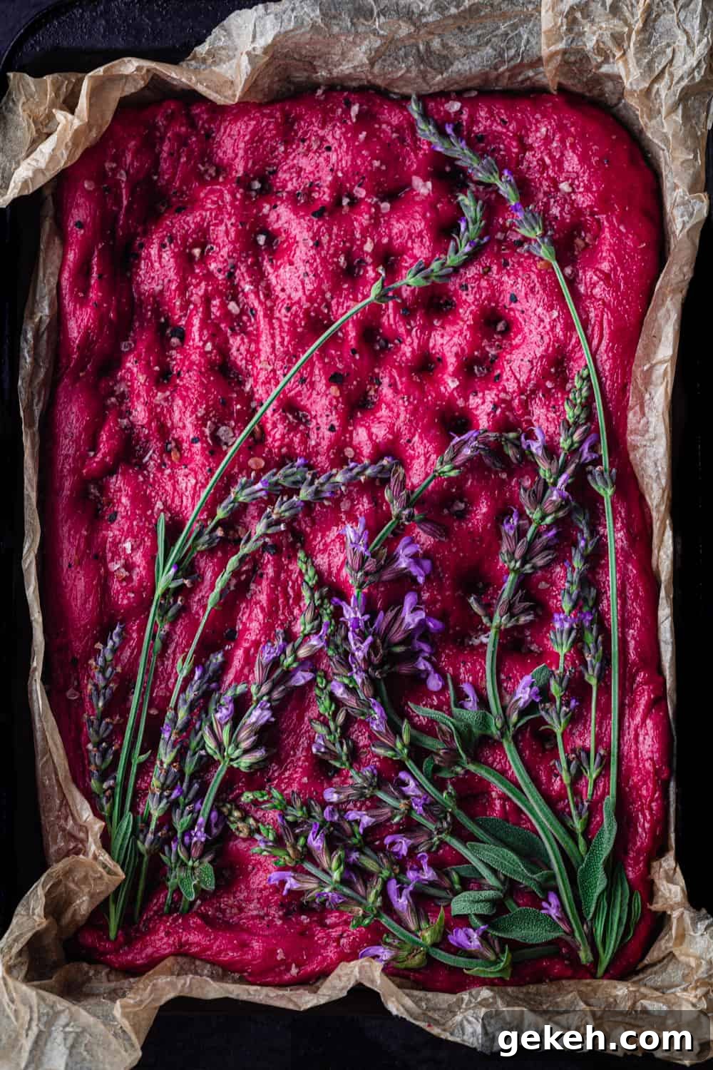 Beet Focaccia: Vibrant No-Knead Magenta Bread Recipe 3 Roasted Beet Focaccia Topped with fresh lavender and sage; overhead shot.