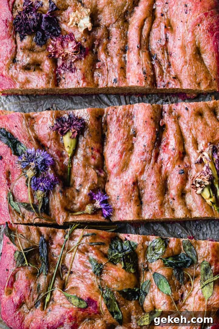 Beet Focaccia: Vibrant No-Knead Magenta Bread Recipe 10 Post oven overhead roasted beet focaccia shot with edible flowers.