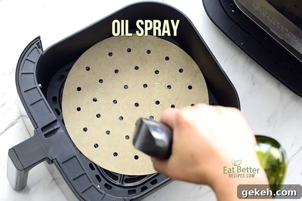 Keto Lemon-Pepper White Fish in the Air Fryer — 15 Minutes 5 Spraying air fryer liner with oil spray