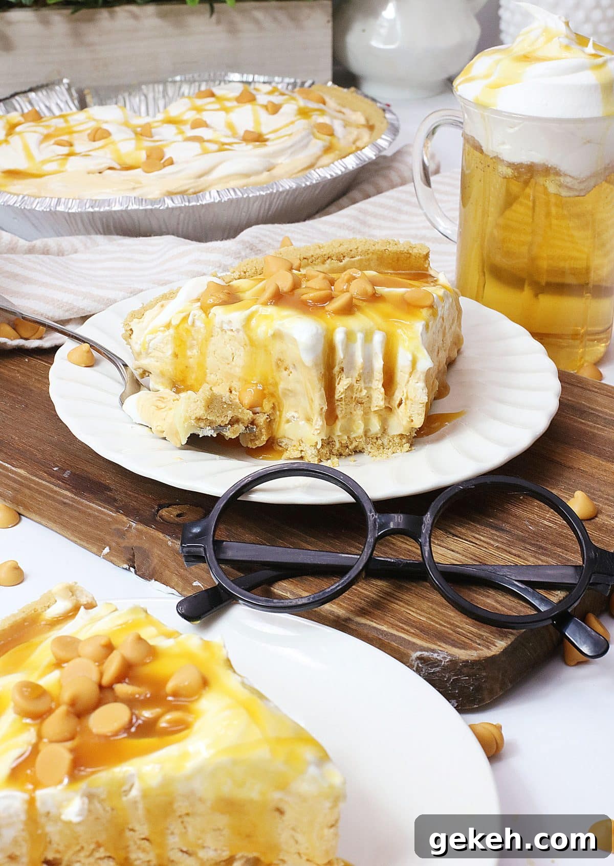 a slice of butterbeer pie topped with caramel sauce on a small white plate