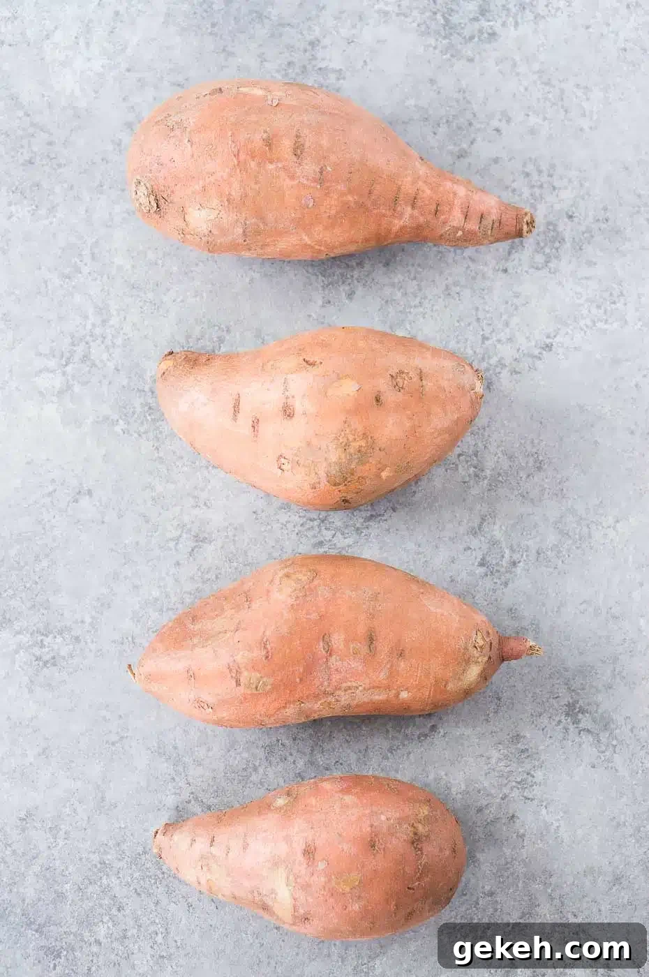 Crispy-Roasted Sweet Potatoes with Garlic and Herbs 4 sweet potatoes on a board