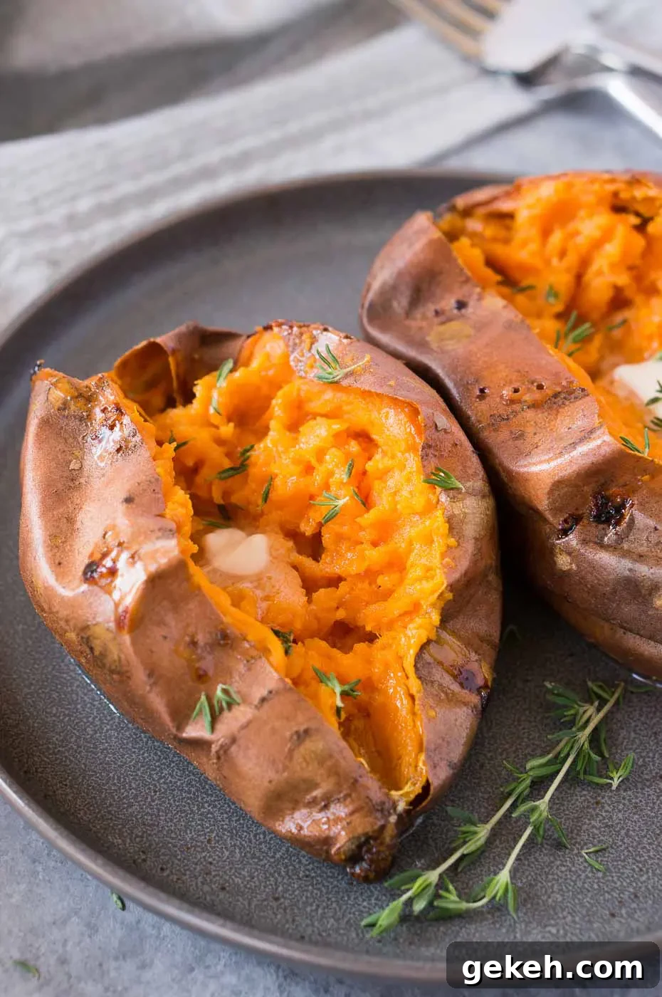 Crispy-Roasted Sweet Potatoes with Garlic and Herbs 6 soft and tender sweet potatoes cut in half on a plate
