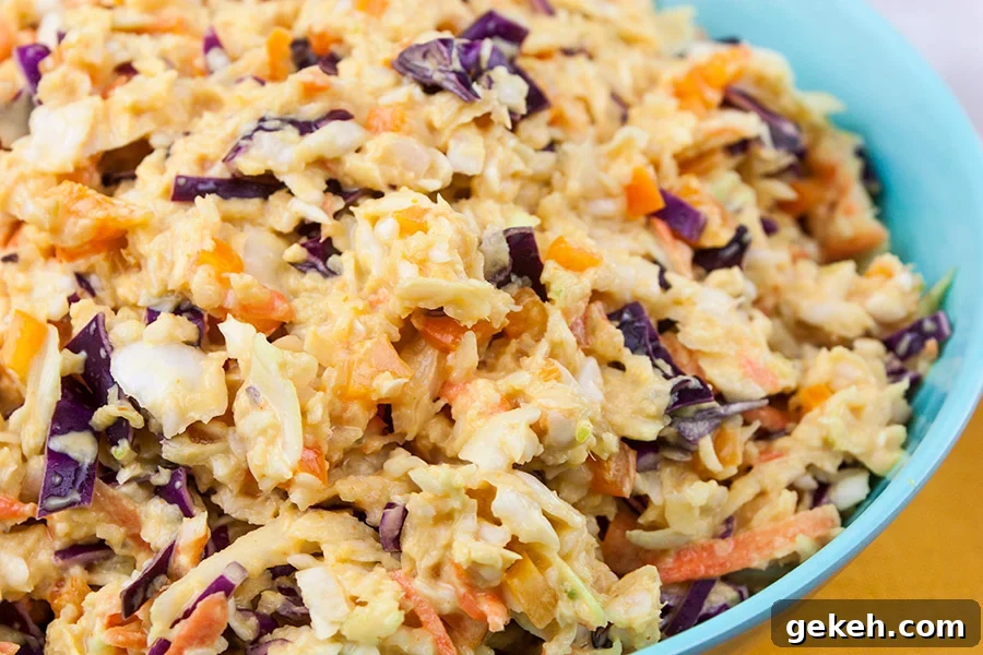 Tangy Southern Mustard Coleslaw in a large blue bowl.