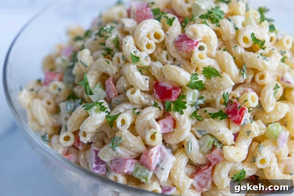 Macaroni salad in a glass bowl.