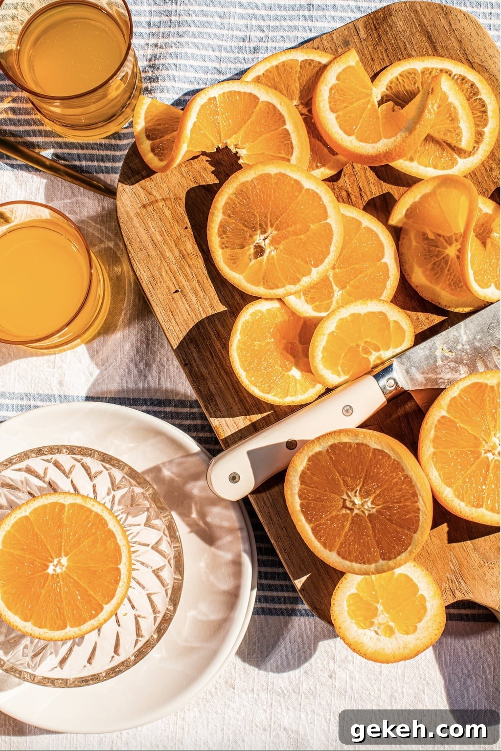 Decadent Chocolate Orange Cake Recipe 4 orange slices on a cutting board with a knife