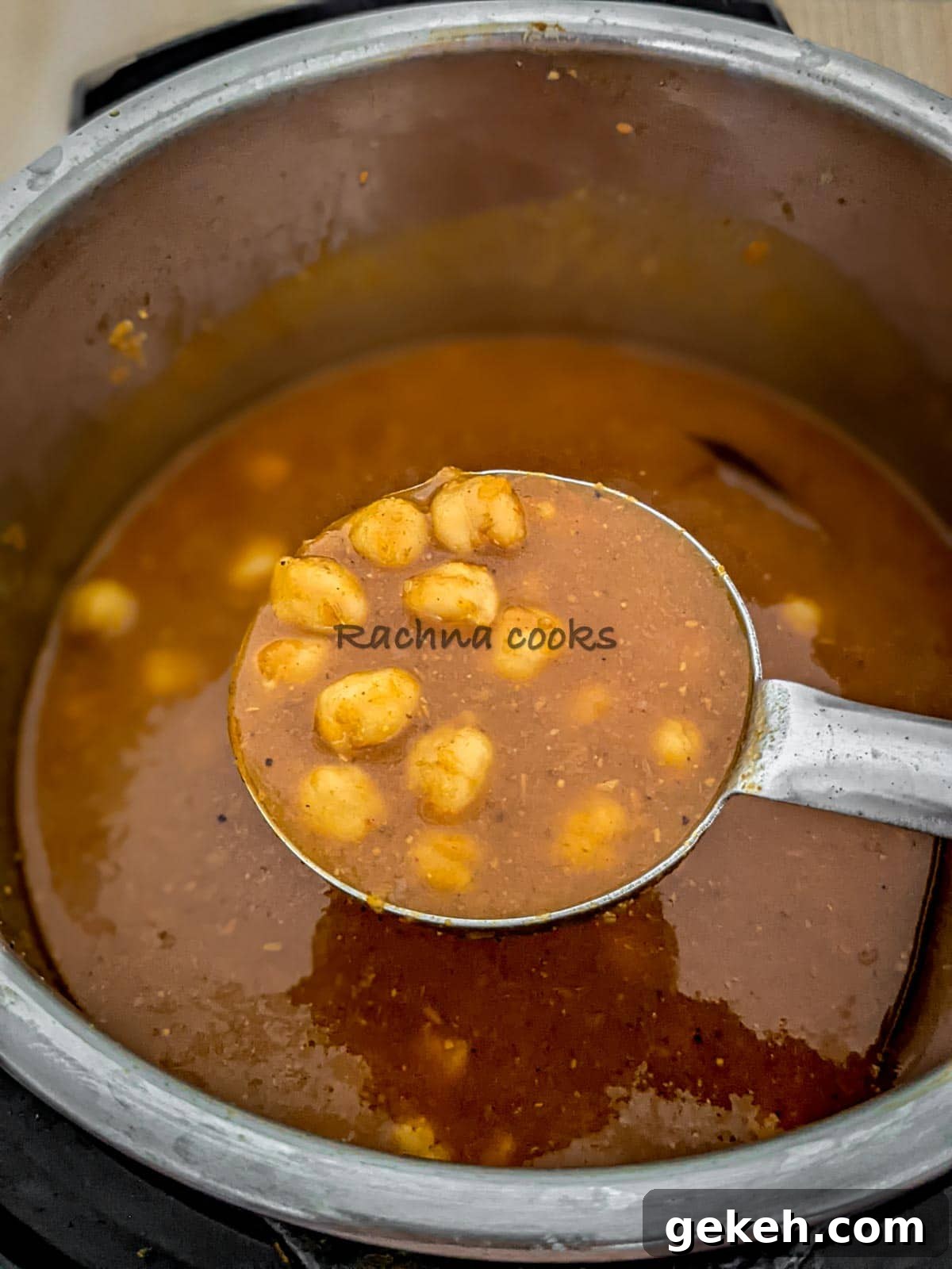 Instant Pot Punjabi Chole (Authentic Chana Masala Recipe) 3 A ladle showing chana masala or chole curry on top of Instant pot.