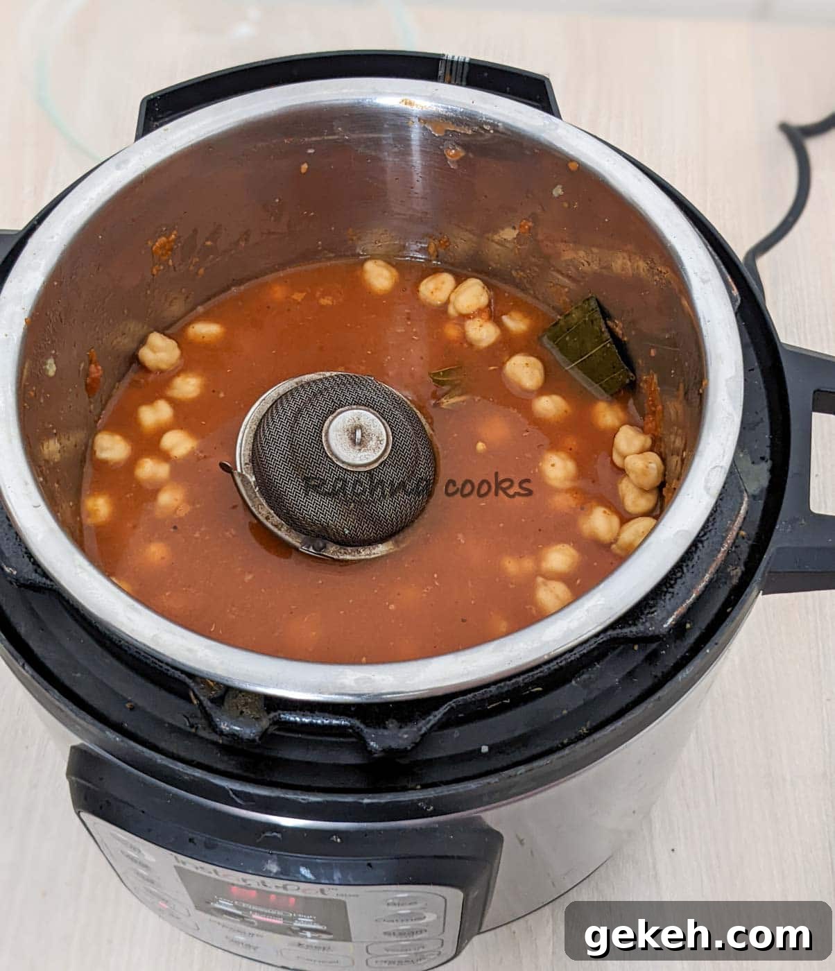 Instant Pot Punjabi Chole (Authentic Chana Masala Recipe) 10 Water and wire mesh with whole spices added to the chole curry.