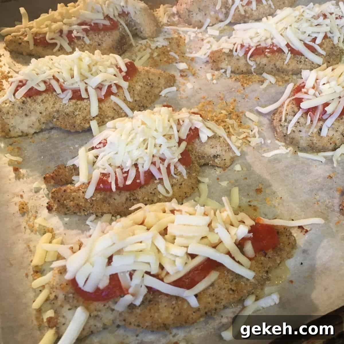 Grated mozzarella cheese and sauce topped on the chicken.