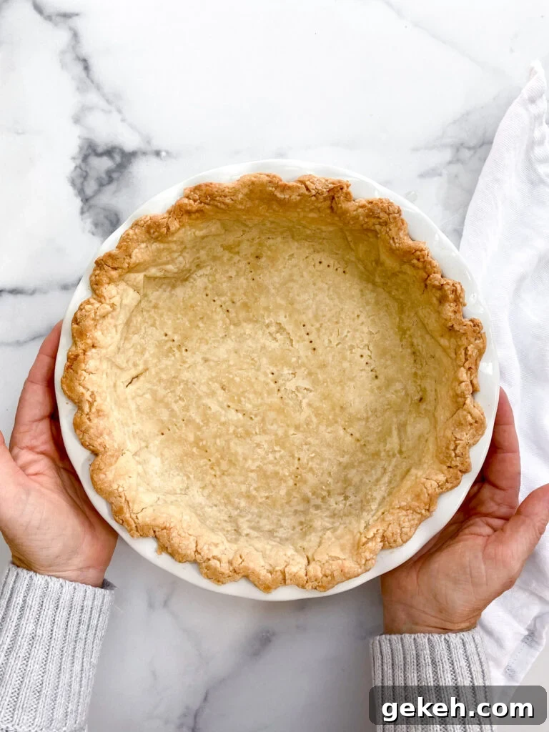 How to Make a Flaky Pie Crust Every Time 2 hands holding the perfect flaky pie crust