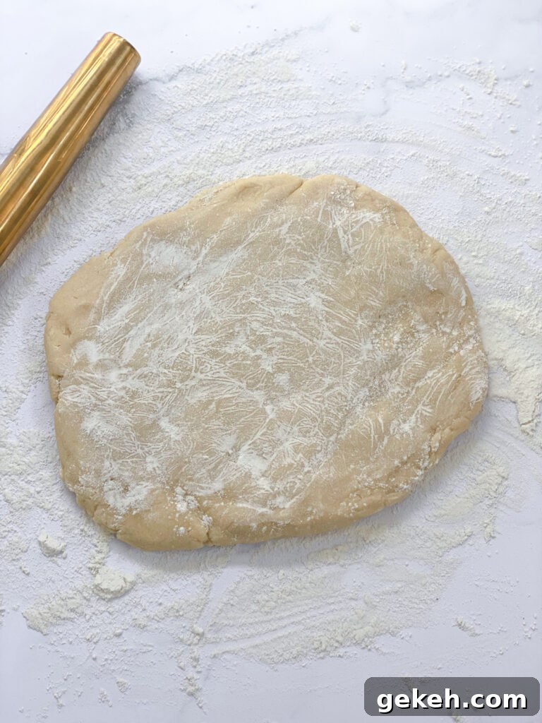 How to Make a Flaky Pie Crust Every Time 14 dough floured and rolling out