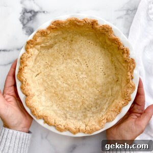 How to Make a Flaky Pie Crust Every Time 22 hands holding the perfect flaky pie crust.