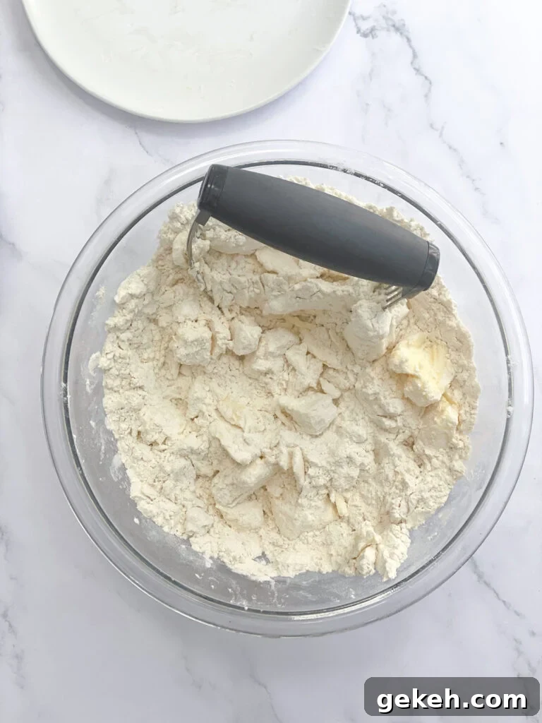How to Make a Flaky Pie Crust Every Time 7 working the dough mixture