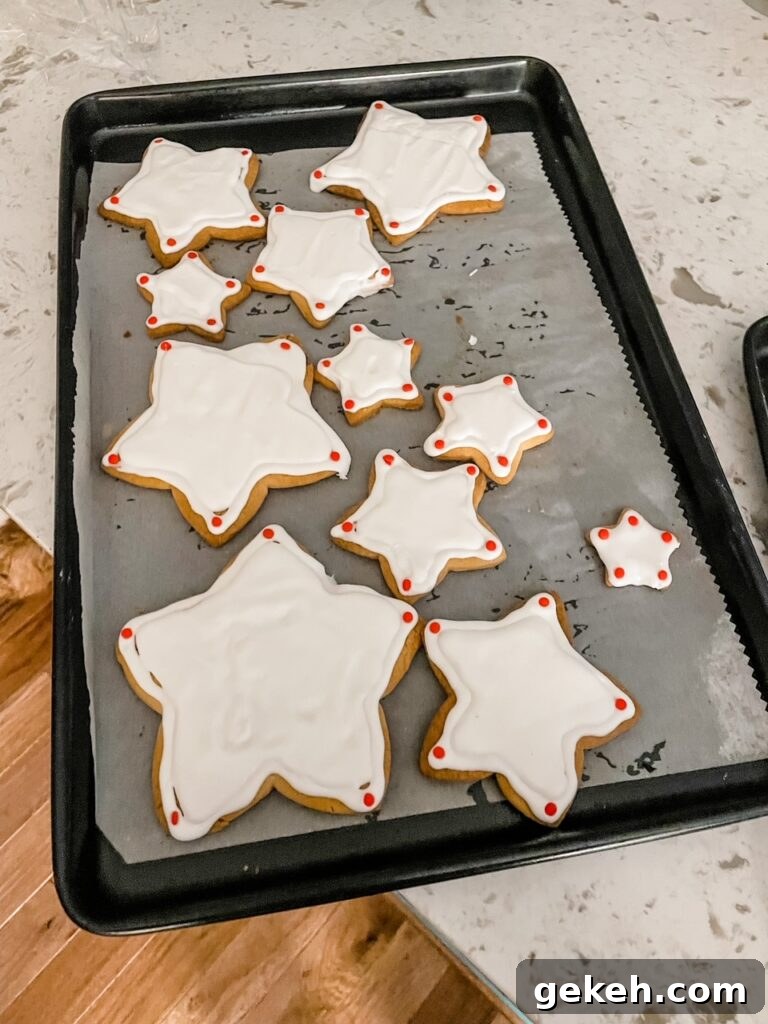 The frosted sugar cookies hardening on the tray