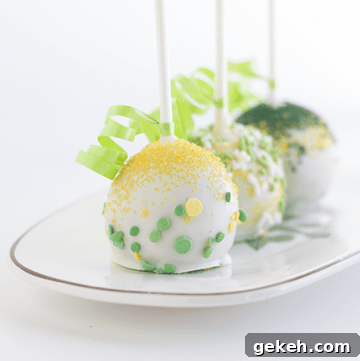 Three chocolate chip cake pops on a plate.
