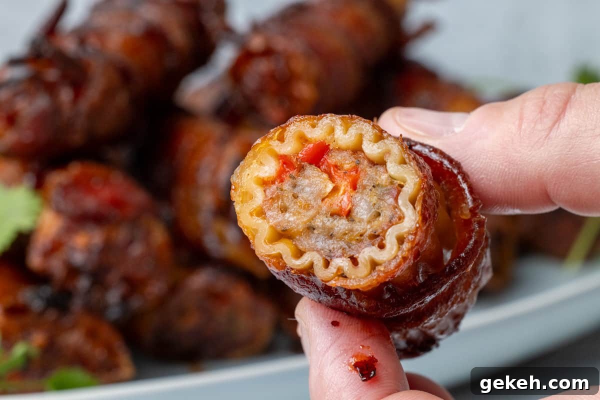 Two fingers holding a stuffed pasta shotgun shell up close showing the meat filling.