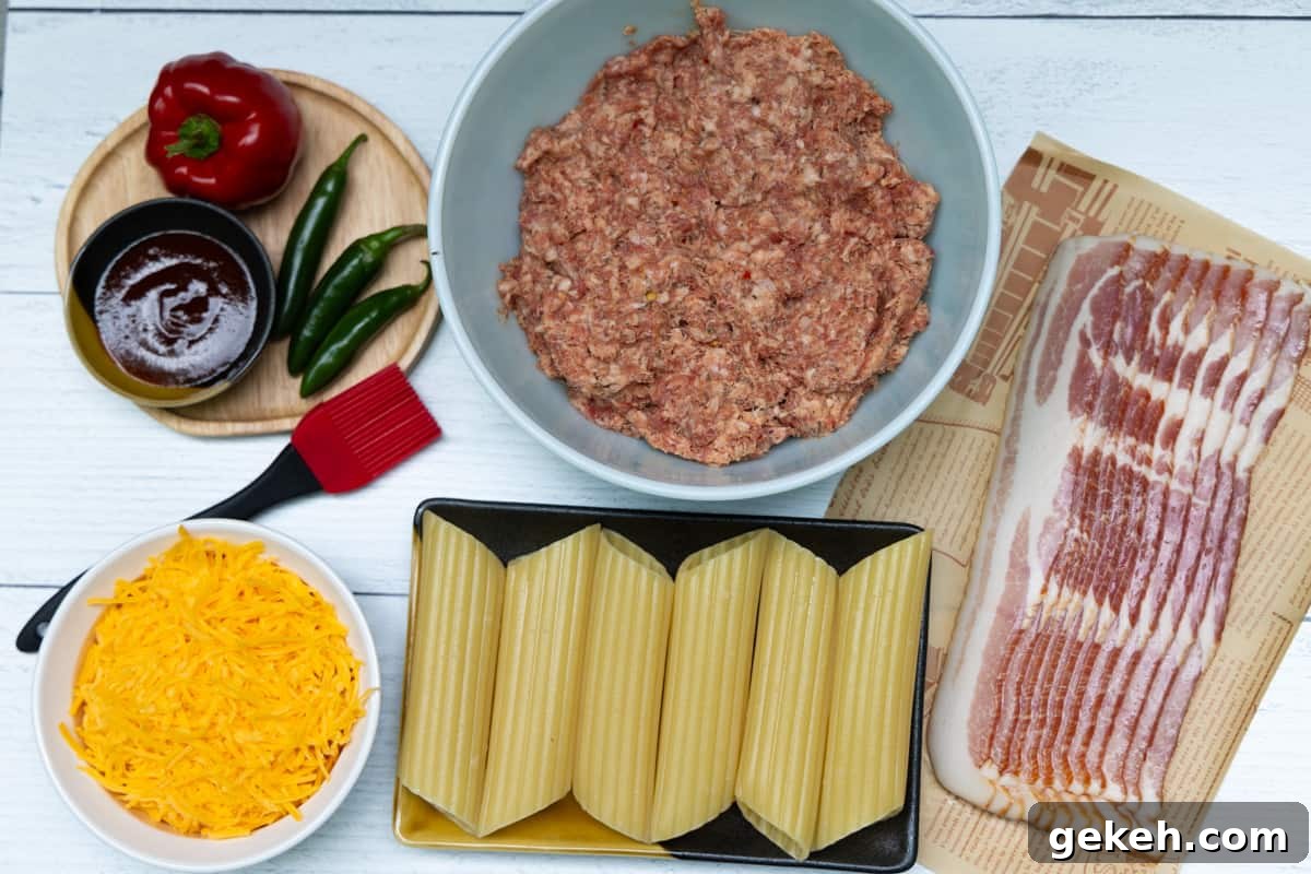 Overhead shot of bacon on paper, manicotti shells, bowl of cheese, peppers, and bowl of ground sausage.