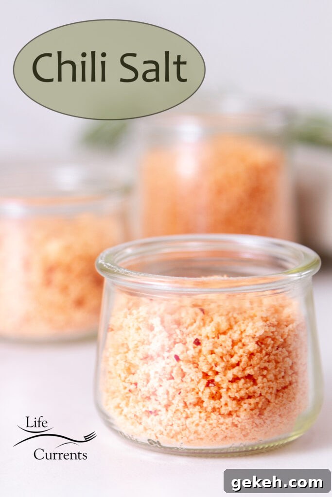 three small glass jars filled with pink chile salt.