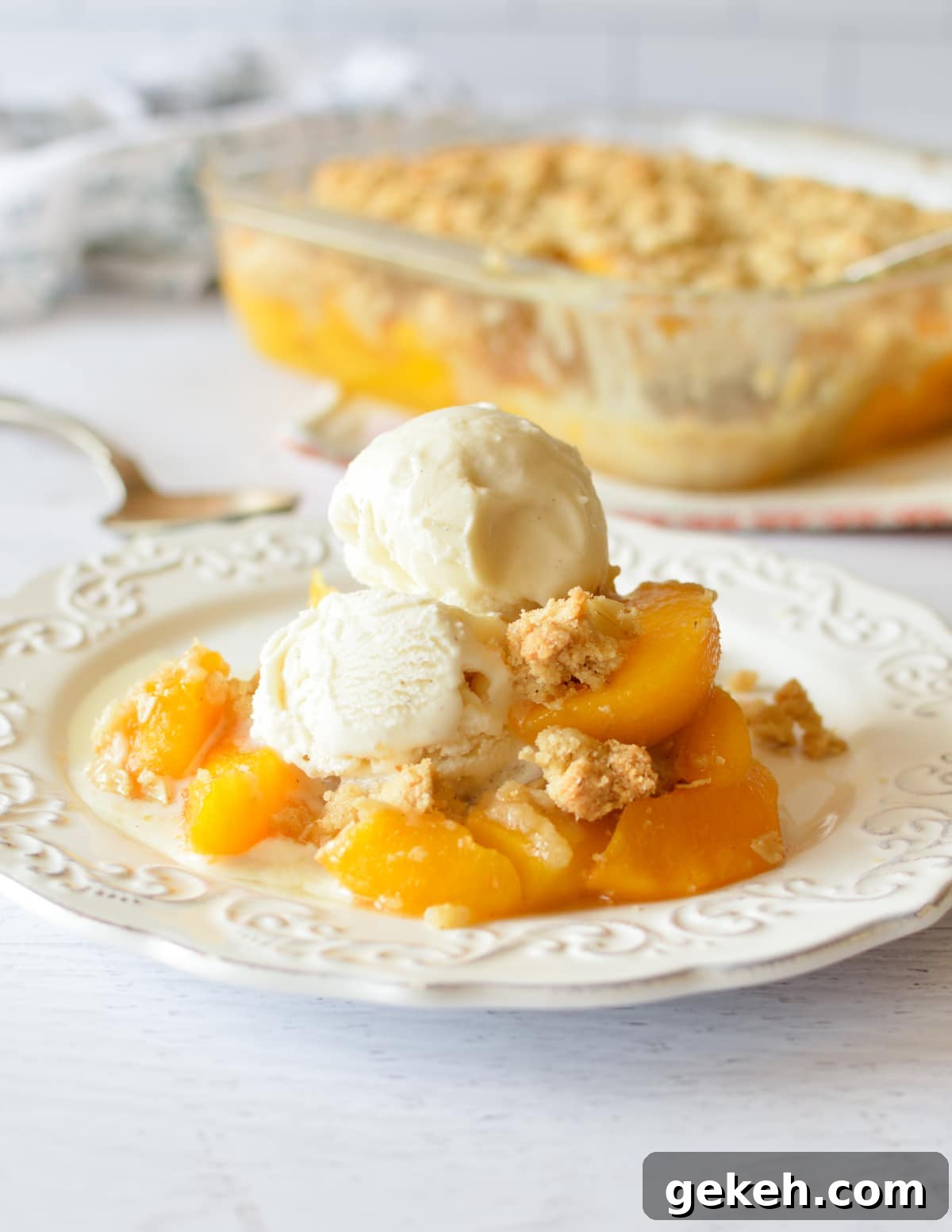 15+ Delicious Canned Peach Recipes for Every Meal 2 peach crisp with vanilla ice cream.